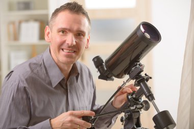 Man looking through telescope clipart