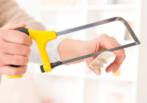 Cutting plastic molding with handsaw — Stock Photo, Image