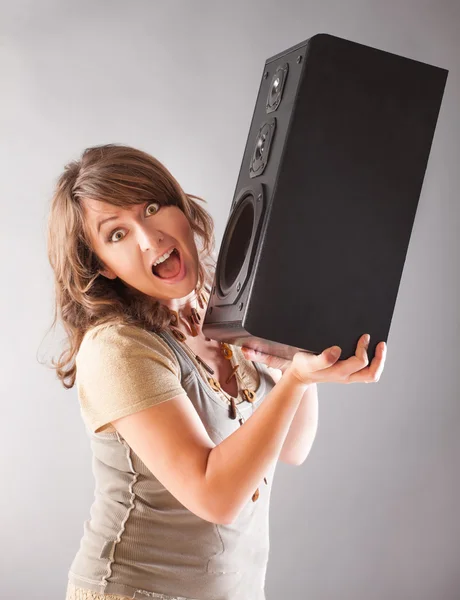 Beautiful woman holding big wooden speaker — Stock Photo, Image