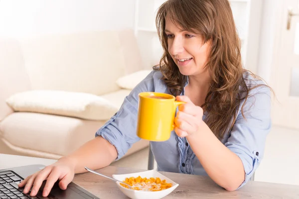 Жінка їсть сніданок вдома — стокове фото