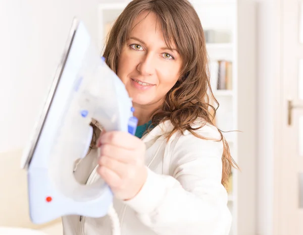 Woman holding iron — Stock Photo, Image