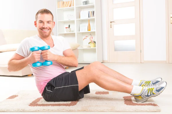 Handsome man holding dumb bells — Stock Photo, Image