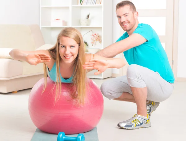 Woman with personal trainer at home — Stock Photo, Image
