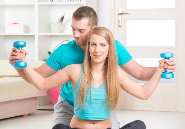 Woman with personal trainer at home — Stock Photo, Image