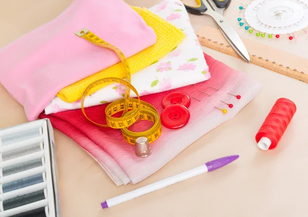 Colorful fabrics and sewing accessories — Stock Photo, Image