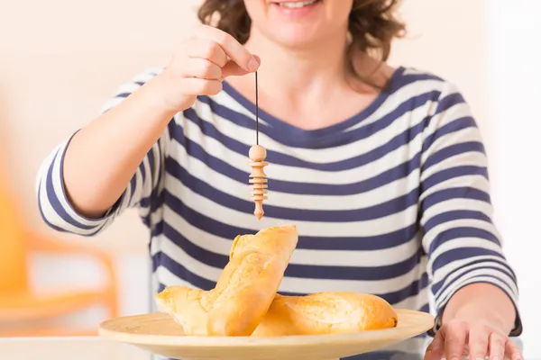 Frau überprüft Nahrung mit Pendel — Stockfoto