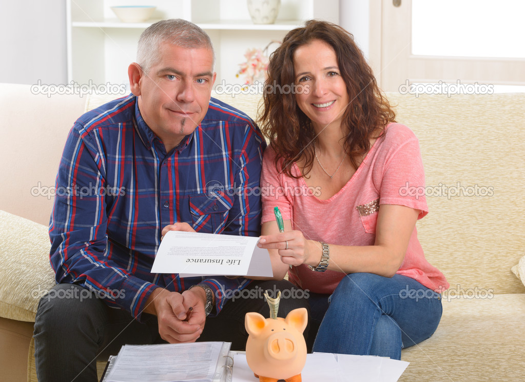 Couple signing life insurance contract