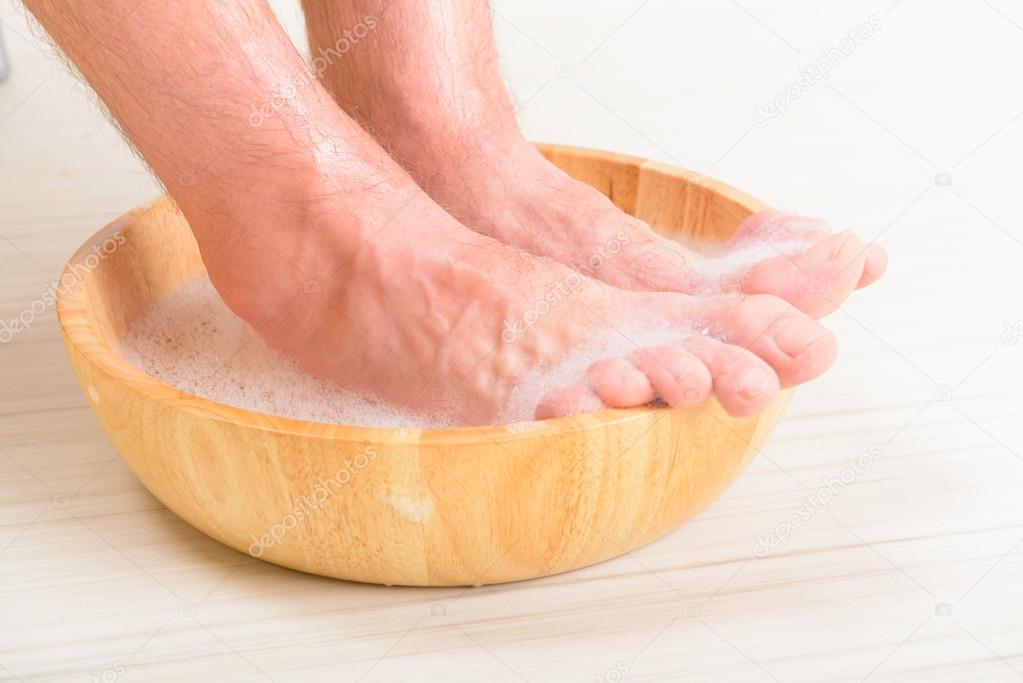 Male feets in a bowl 