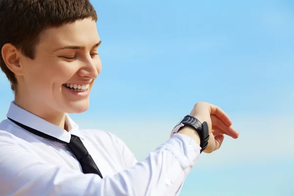 Woman looks at her watch — Stock Photo, Image