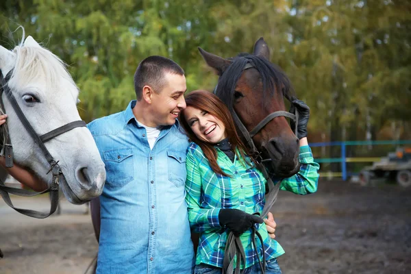 Couple with horses — Stock Photo, Image