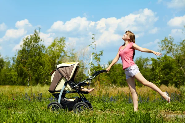 Young mother with a stroller — Stock Photo, Image