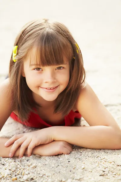 Girl lying on the sand — Stock Photo, Image