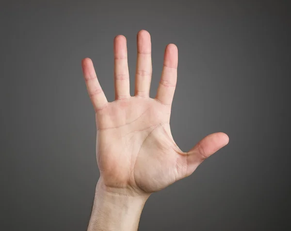 Mano abierta sobre fondo oscuro — Foto de Stock