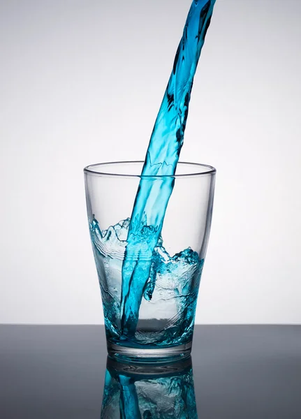 Water pouring into a glass — Stock Photo, Image