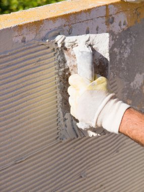 fayans yapıştırıcı mala ile yayılan adam