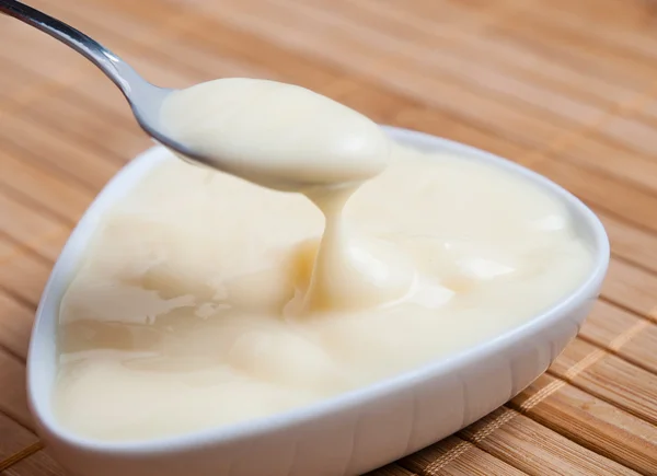 Spoonful of custard — Stock Photo, Image