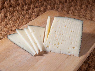 Slices of spanish cheese clipart