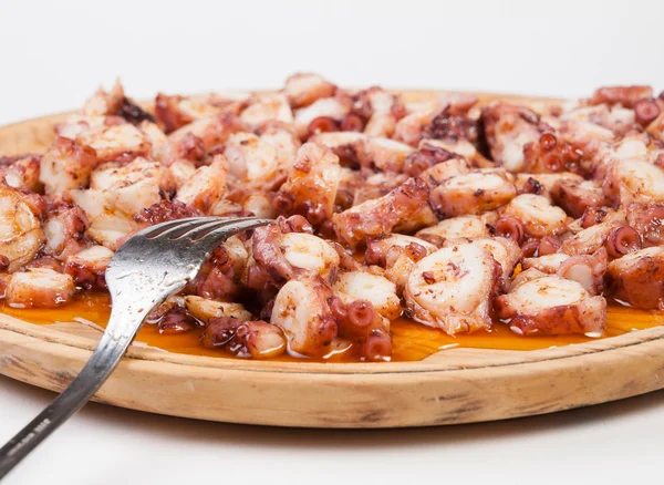 Pulpo a feira in a wooden plate with fork — Stock Photo, Image