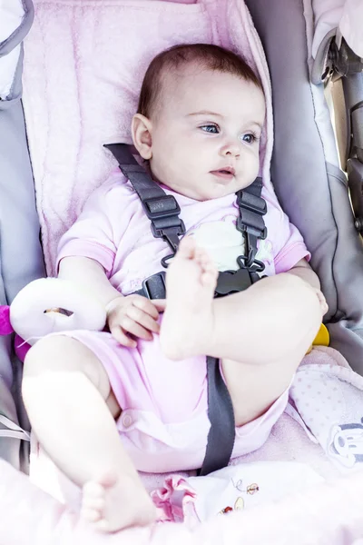 Schattige babymeisje in wandelwagen. — Stockfoto