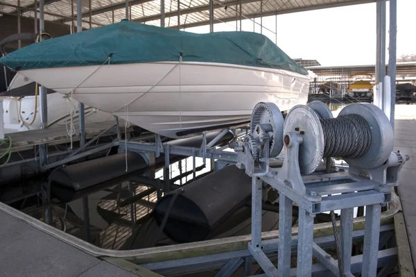 Docked boat on a lift — Stock Photo, Image