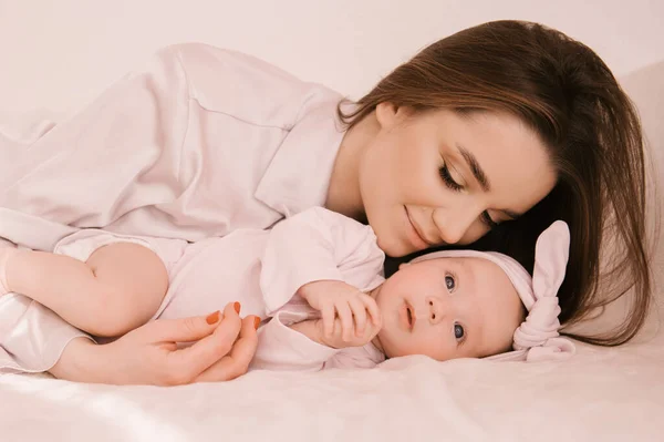 Loving Smiling Young Mother Her Newborn Daughter Light Background — Stock Photo, Image