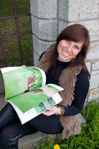 Girl with photo book — Stock Photo, Image