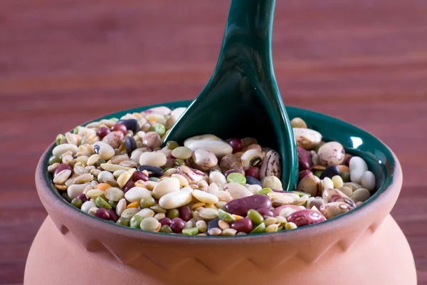 Mix of legumes in an earthenware jar — Stock Photo, Image