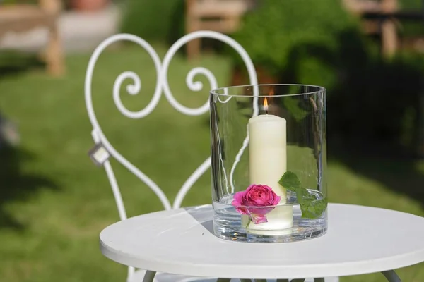 Garden table, garden chair, candle, glass, water, rose, heart
