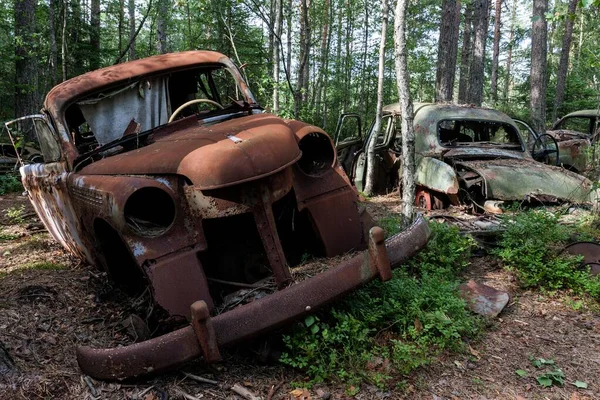 Junkyard in the forest, junk cars, 40s in Ryd, Smland, Sweden, Europe