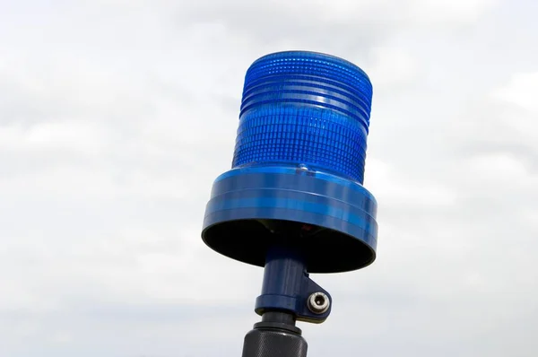 Blue signal lamp against the sky