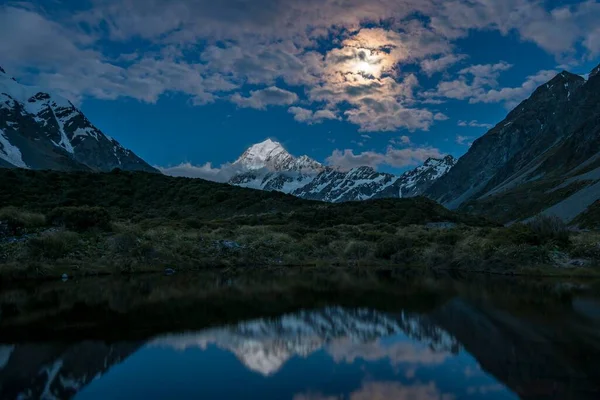Mount Cook is reflected at moonlight in the pond, Hooker Valley, Aoraki Mount Cook National Park, Canterbury Region, Southland, New Zealand, Oceania