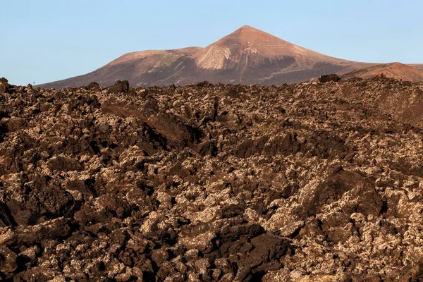 Lava field, volcanic landscape, Guardilama volcano at the back, Lanzarote, Canary Islands, Spain, Europe