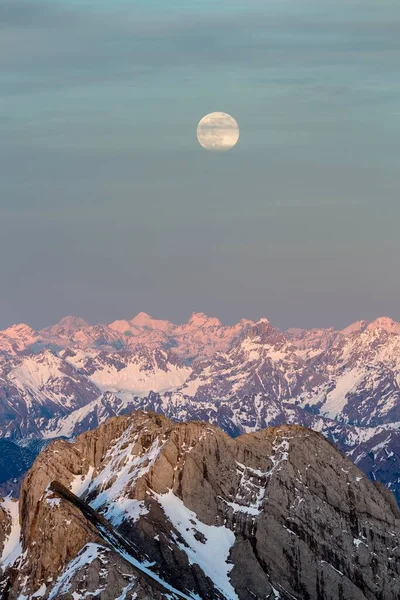 Sntis Mountain overlooking Alpstein massif at full moon, Appenzell Alps, Appenzell, Switzerland, Europe