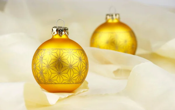 Two Gold Baubles Chiffon Cloth — Stock Photo, Image