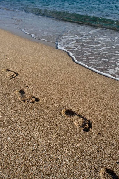 Footprints in the sand, island of Karpathos, Aegean Islands, Aegean Sea, Greece, Europe