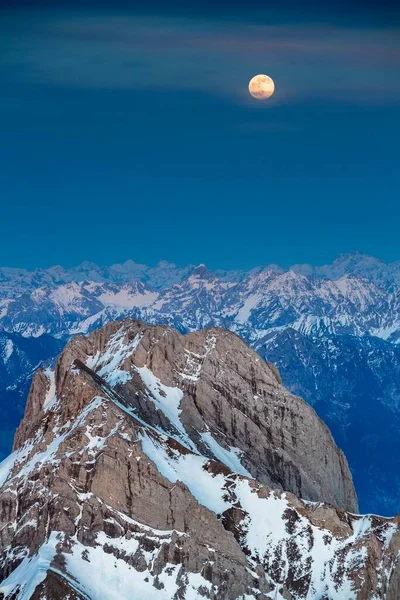 Sntis Mountain overlooking Alpstein massif at full moon, Appenzell Alps, Appenzell, Switzerland, Europe