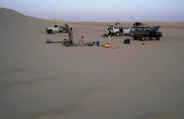 Desert camp with camp fire in the sand dunes, Libya, Africa