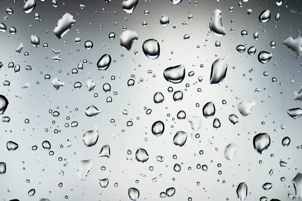 Water drops on a window pane, glass pane, window, rain, bad weather, full-frame, background image