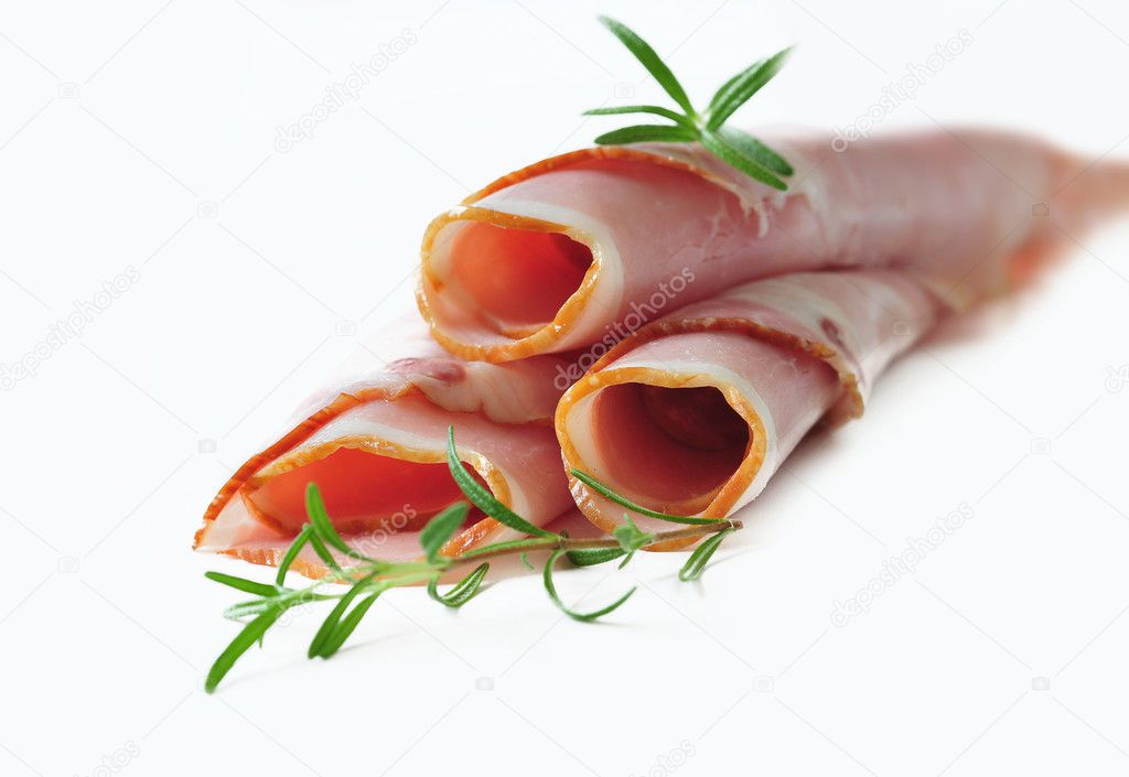 Sliced pork ham on the white background with herbs and spices