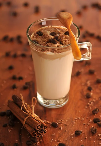 Cold fresh ice coffee with coffee beans and cinnamon - close up — Stock Photo, Image