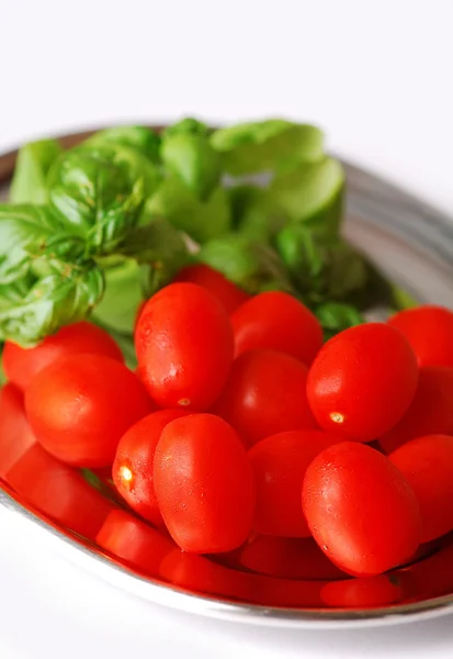 Fresh wet cherry tomatoes with basil — Stock Photo, Image