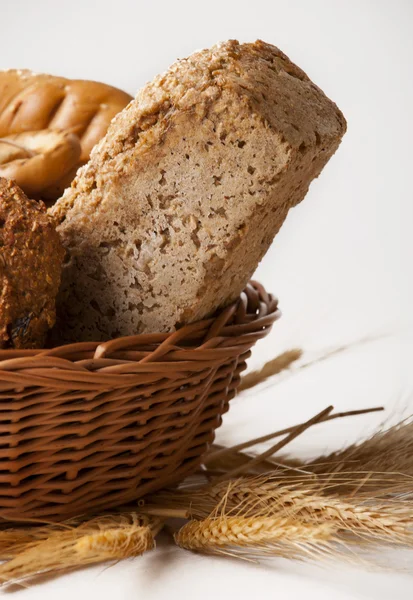 Bread with grain and ears in the basket — Stock Photo, Image