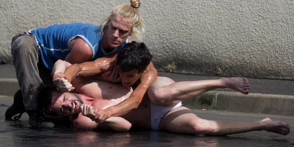 Twee semi-naakte dansers zijn gevechten op de grond. — Stockfoto