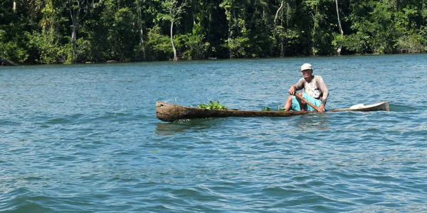 Man rowing in a dugout — Stock Photo, Image