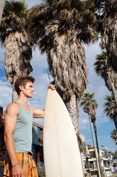 An active young man with a surfboard — Stock Photo, Image