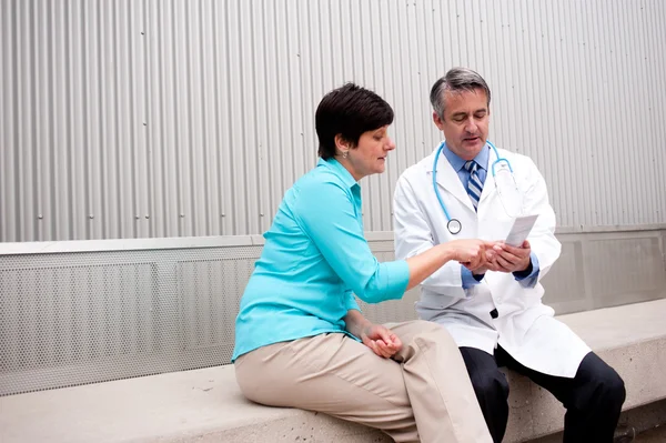 Mature doctor with female patient — Stock Photo, Image
