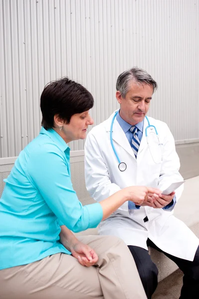 Mature doctor with female patient — Stock Photo, Image