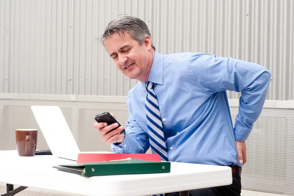 Businessman under stress and pain — Stock Photo, Image