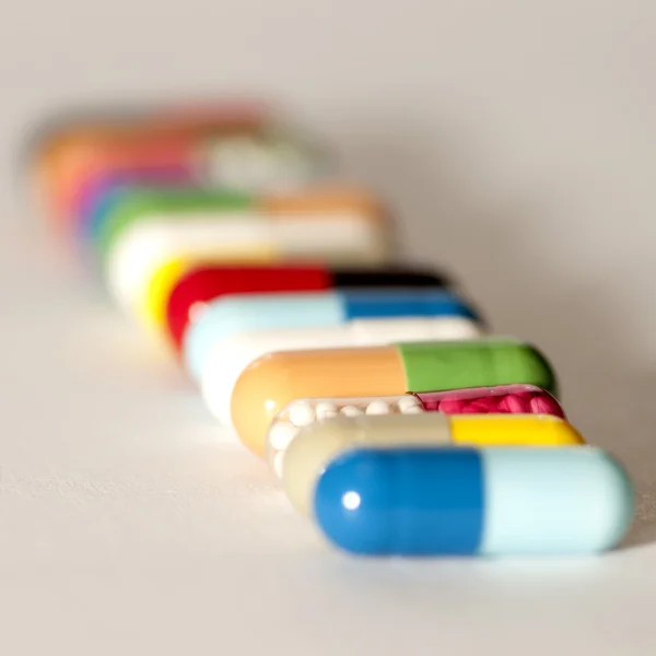 Various capsules in row — Stock Photo, Image