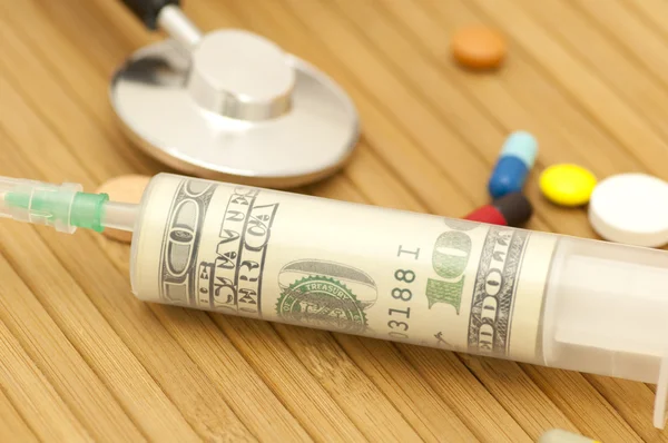 Money in syringe — Stock Photo, Image